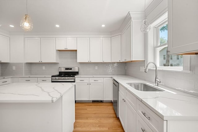 13 River Unit 2, Danvers, MA 01923 - kitchen with appliances with stainless steel finishes, white cabinetry, tasteful backsplash, pendant lighting, and recessed lighting
