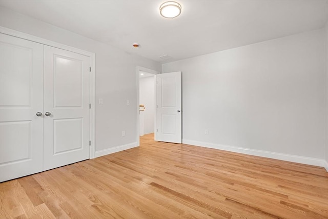 13 River Unit 2, Danvers, MA 01923 - unfurnished bedroom featuring light wood-style flooring and a closet