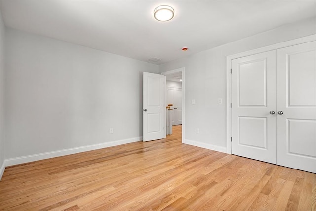13 River Unit 2, Danvers, MA 01923 - unfurnished bedroom featuring light wood finished floors and a closet