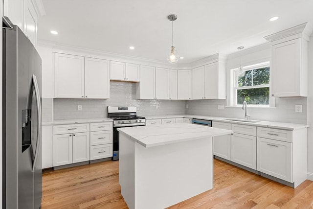13 River Unit 2, Danvers, MA 01923 - kitchen featuring stainless steel appliances, white cabinets, decorative backsplash, decorative light fixtures, and light stone counters
