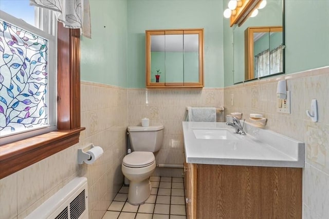 639 Washington St, Walpole, MA 02032 - bathroom with toilet, wainscoting, vanity, tile walls, and tile patterned flooring