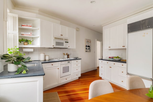 kitchen featuring light hardwood / wood-style floors, tasteful backsplash, white cabinets, white appliances, and crown molding