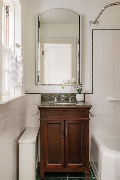 bathroom with vanity, tile walls, and tile patterned floors