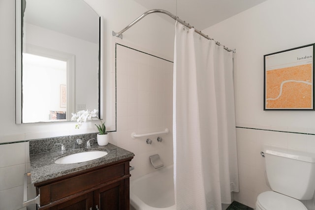 full bathroom with tile walls, shower / tub combo with curtain, vanity, and toilet