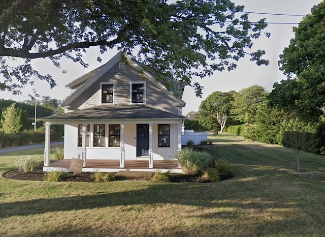 view of front of house with a porch and a front yard