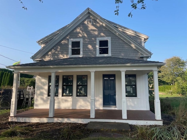 view of front of house with covered porch and roof with shingles