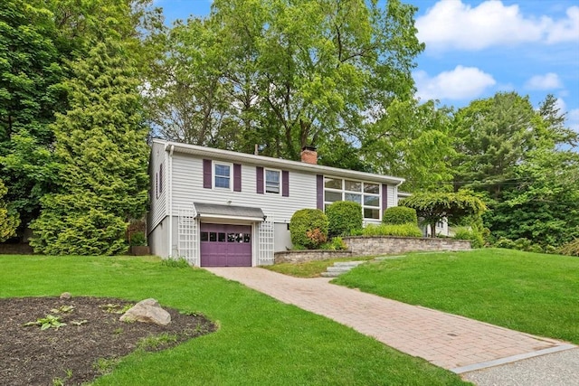 10 Powderhouse Cir, Wilmington, MA 01887 - view of front of property featuring driveway, an attached garage, a front yard, and a chimney