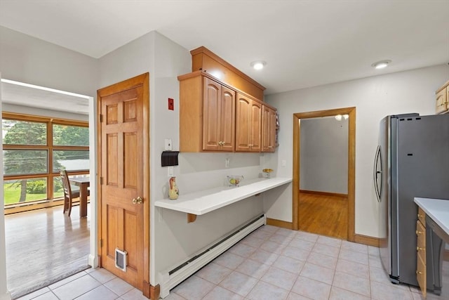 10 Powderhouse Cir, Wilmington, MA 01887 - kitchen featuring freestanding refrigerator, a baseboard radiator, light tile patterned flooring, light countertops, and baseboards