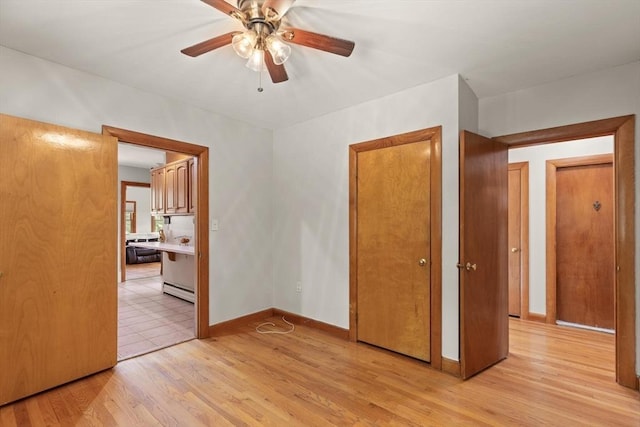 10 Powderhouse Cir, Wilmington, MA 01887 - empty room featuring light wood-type flooring, a ceiling fan, baseboards, and baseboard heating