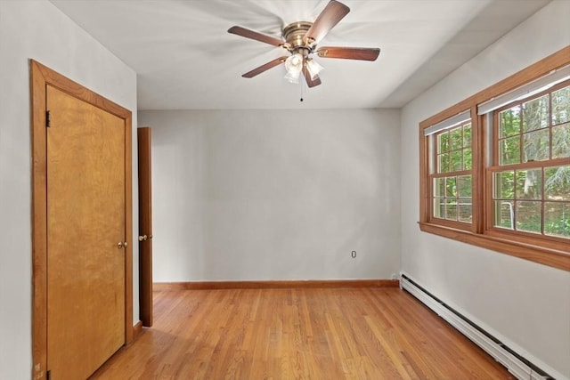 10 Powderhouse Cir, Wilmington, MA 01887 - spare room featuring baseboard heating, light wood finished floors, baseboards, and ceiling fan