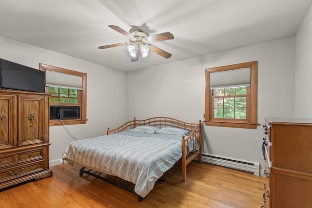 10 Powderhouse Cir, Wilmington, MA 01887 - bedroom featuring a baseboard radiator, multiple windows, light wood-style floors, and ceiling fan