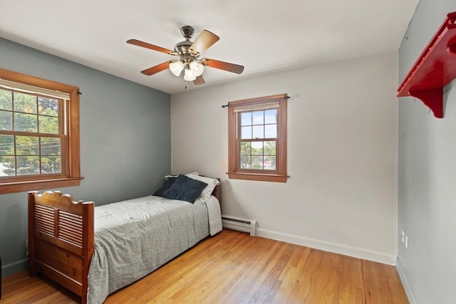 10 Powderhouse Cir, Wilmington, MA 01887 - bedroom with a baseboard radiator, baseboards, wood finished floors, and a ceiling fan