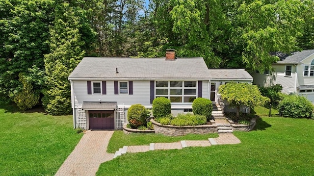 10 Powderhouse Cir, Wilmington, MA 01887 - view of front facade featuring decorative driveway, a chimney, a garage, and a front yard