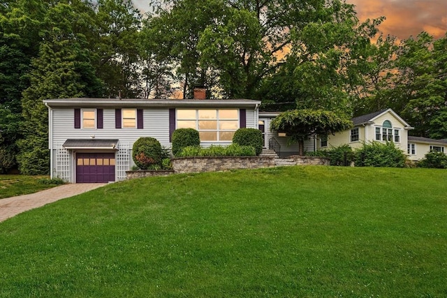 10 Powderhouse Cir, Wilmington, MA 01887 - view of front of house with driveway, a chimney, an attached garage, and a front lawn