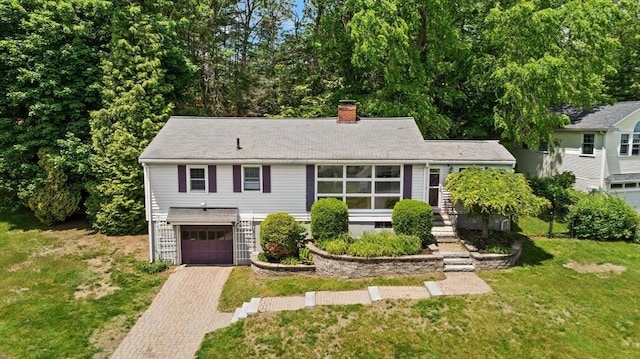 10 Powderhouse Cir, Wilmington, MA 01887 - view of front of property featuring a chimney, decorative driveway, an attached garage, and a front yard