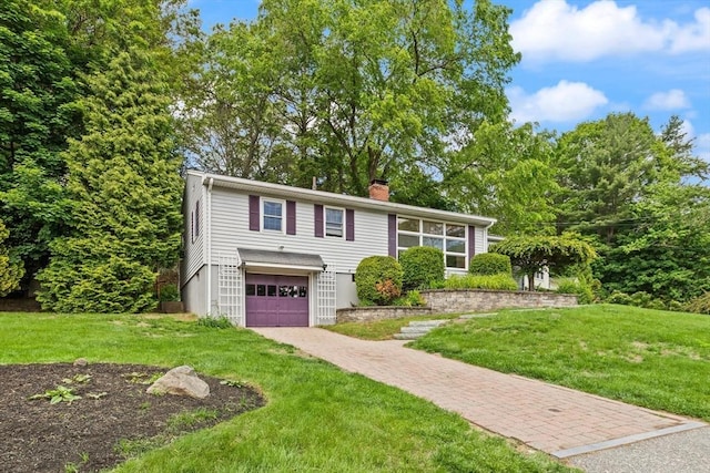 10 Powderhouse Cir, Wilmington, MA 01887 - view of front of property featuring decorative driveway, a garage, a front lawn, and a chimney