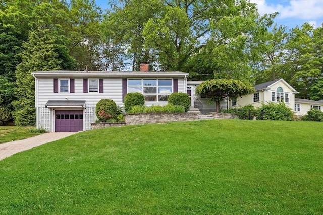 10 Powderhouse Cir, Wilmington, MA 01887 - view of front of home featuring a chimney, a garage, driveway, and a front lawn