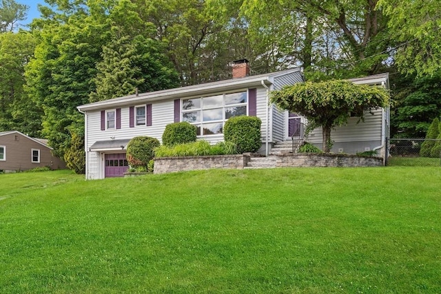 10 Powderhouse Cir, Wilmington, MA 01887 - view of front of house with a chimney and an attached garage