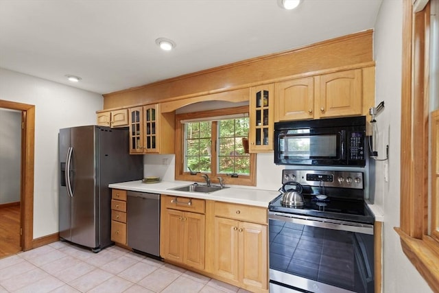 10 Powderhouse Cir, Wilmington, MA 01887 - kitchen with stainless steel appliances, a sink, light countertops, glass insert cabinets, and light brown cabinetry