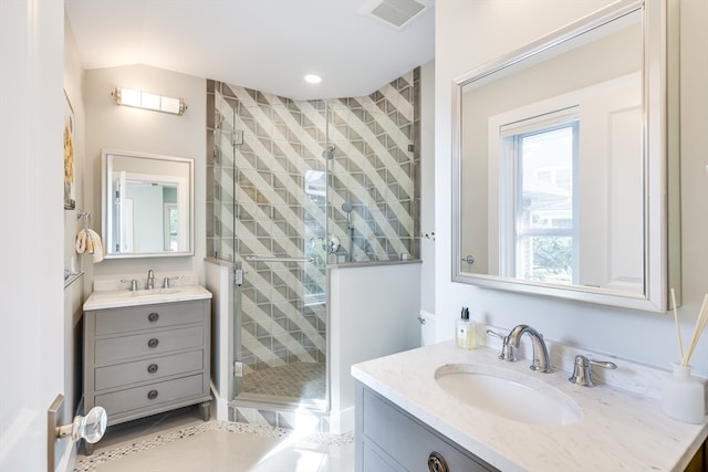 bathroom with tile patterned floors, a shower with shower door, and vanity