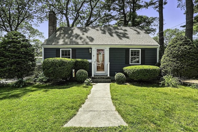 7 Vermont Ave, Natick, MA 01760 - view of front of property featuring a chimney, a front yard, and roof with shingles