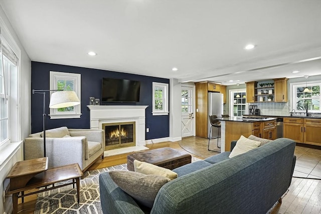 7 Vermont Ave, Natick, MA 01760 - living room with recessed lighting, a fireplace with flush hearth, and light wood-style floors