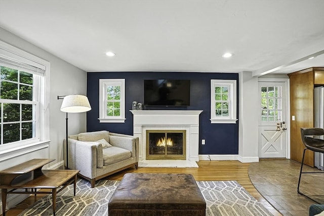 7 Vermont Ave, Natick, MA 01760 - living room featuring a warm lit fireplace, wood finished floors, recessed lighting, and healthy amount of natural light