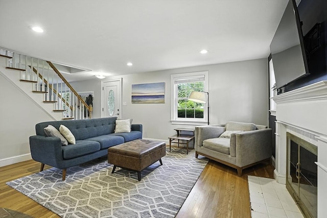 7 Vermont Ave, Natick, MA 01760 - living room featuring stairs, light wood-type flooring, a fireplace, and recessed lighting