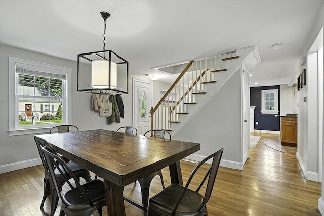 7 Vermont Ave, Natick, MA 01760 - dining space with light wood-type flooring and stairway