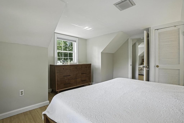 7 Vermont Ave, Natick, MA 01760 - bedroom featuring wood finished floors, lofted ceiling, and a closet