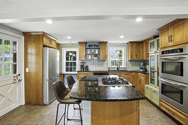 7 Vermont Ave, Natick, MA 01760 - kitchen featuring appliances with stainless steel finishes, open shelves, brown cabinets, a breakfast bar area, and decorative backsplash