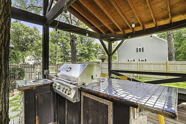 7 Vermont Ave, Natick, MA 01760 - fenced backyard featuring exterior kitchen and view of scattered trees
