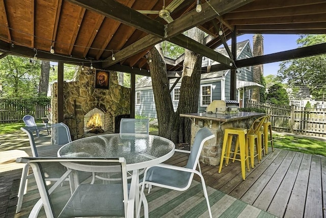 7 Vermont Ave, Natick, MA 01760 - wooden terrace with a fenced backyard, outdoor dining space, and an outdoor stone fireplace
