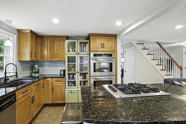 7 Vermont Ave, Natick, MA 01760 - kitchen featuring stainless steel appliances, brown cabinetry, tasteful backsplash, dark stone counters, and glass insert cabinets