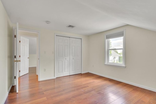 17-1 Parkers Ln Unit 1, Waltham, MA 02453 - unfurnished bedroom with light wood-type flooring, lofted ceiling, baseboards, and a closet