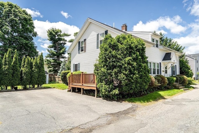 17-1 Parkers Ln Unit 1, Waltham, MA 02453 - view of home's exterior with a chimney and a wooden deck