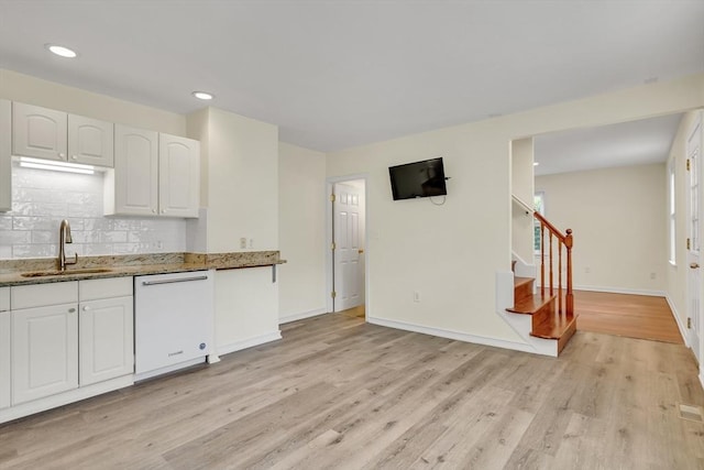 17-1 Parkers Ln Unit 1, Waltham, MA 02453 - kitchen with dishwasher, a sink, light wood-type flooring, light stone counters, and decorative backsplash