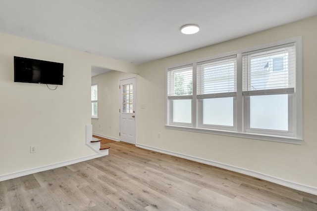 17-1 Parkers Ln Unit 1, Waltham, MA 02453 - unfurnished living room with light wood-type flooring, baseboards, and stairs