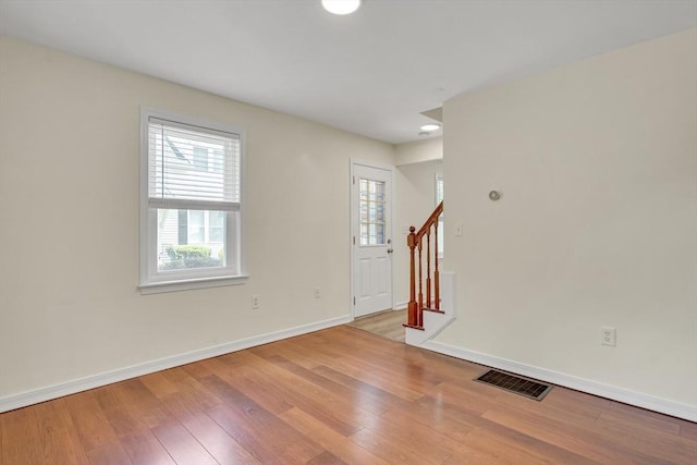 17-1 Parkers Ln Unit 1, Waltham, MA 02453 - spare room with stairs, wood-type flooring, and baseboards