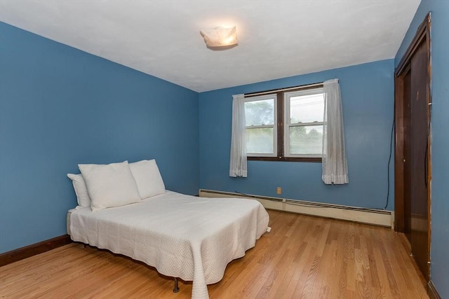 200 Dana Ave, Boston, MA 02136 - bedroom featuring a baseboard heating unit, light wood-style floors, and baseboards