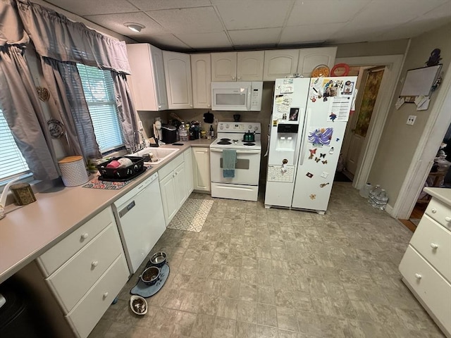 62 Marion St, Fitchburg, MA 01420 - kitchen featuring white appliances, a paneled ceiling, light countertops, and white cabinets
