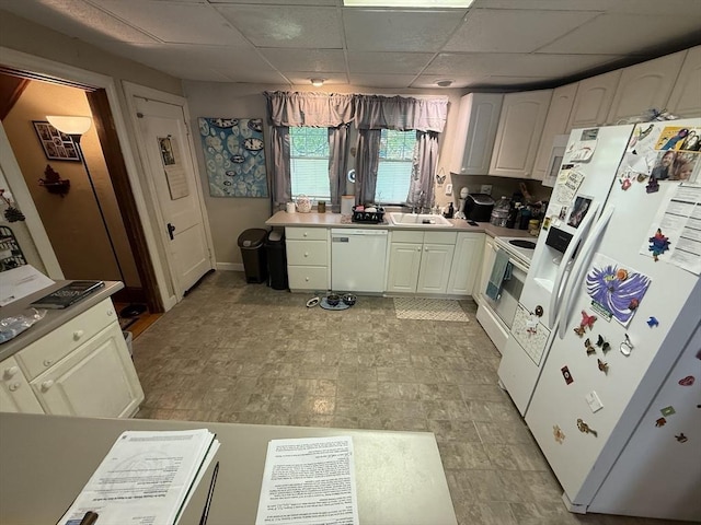 62 Marion St, Fitchburg, MA 01420 - kitchen with white appliances, white cabinetry, light countertops, and a paneled ceiling