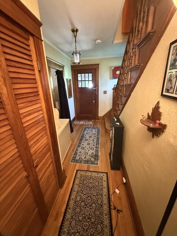 62 Marion St, Fitchburg, MA 01420 - entrance foyer with wood finished floors, stairway, and crown molding
