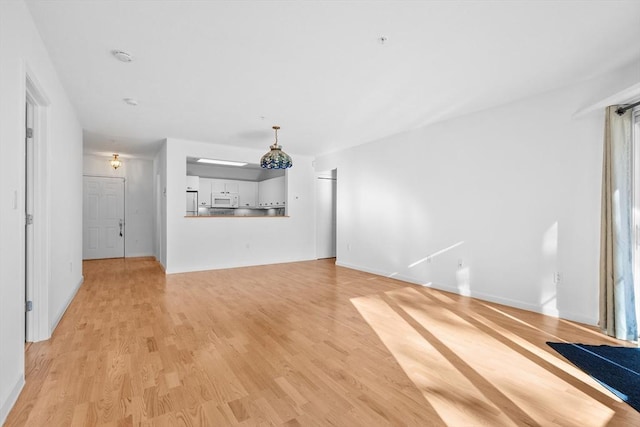 unfurnished living room with light hardwood / wood-style flooring