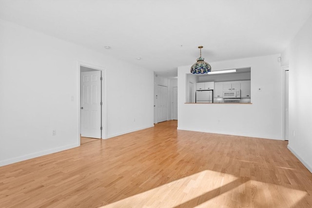 unfurnished living room with light hardwood / wood-style floors