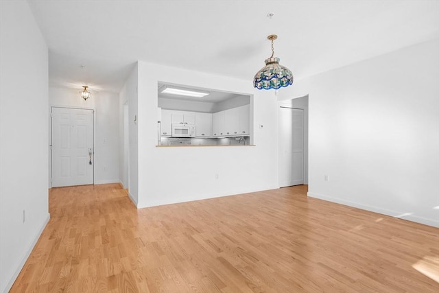 unfurnished living room with light hardwood / wood-style flooring