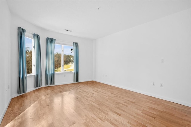 unfurnished room featuring light hardwood / wood-style floors