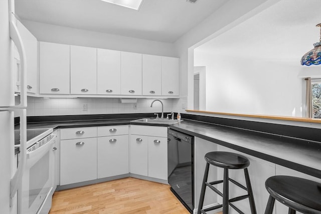 kitchen with white cabinets, sink, range, and black dishwasher