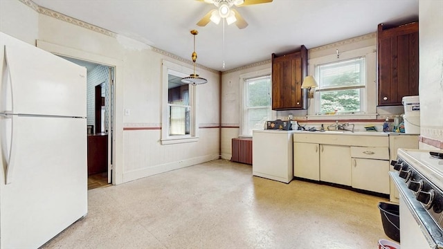 11 Quincy Ave, Norwood, MA 02062 - kitchen with white appliances, radiator, a ceiling fan, wainscoting, and light countertops