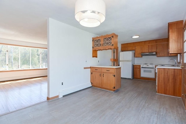 kitchen with freestanding refrigerator, under cabinet range hood, baseboard heating, range, and light wood-style floors